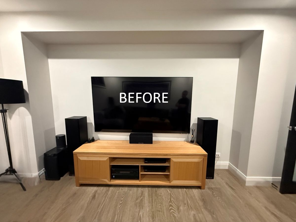 TV setup with wooden entertainment unit, speakers, and "BEFORE" text overlay, illustrating home decor improvement.