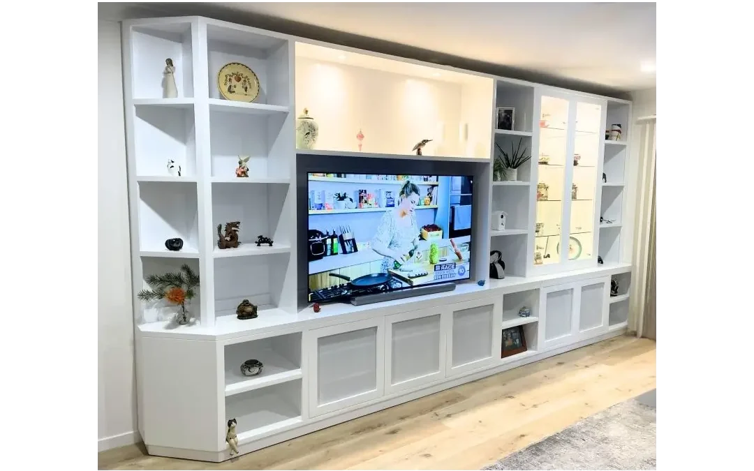 Custom-made white wall unit with shelving and integrated television, showcasing decorative items, designed for stylish home storage in Central Coast, NSW.