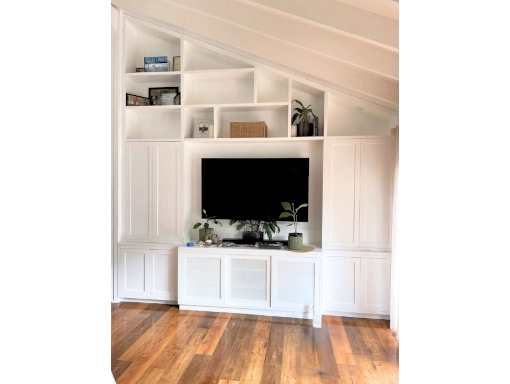 Coastal-Design-Furniture-custom-made-all-unit-under-stairs-510x384 Custom white entertainment unit with handcrafted cabinetry and solid timber, enhancing a modern living space.